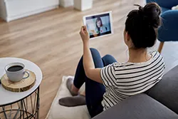 Woman attending online therapy on tablet